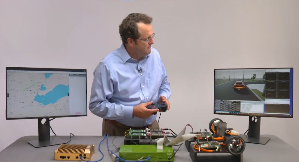 Curt Hillier of N X P Semiconductors controls an H E V processor-in-the-loop simulation while watching a 3 D simulation of the vehicle.